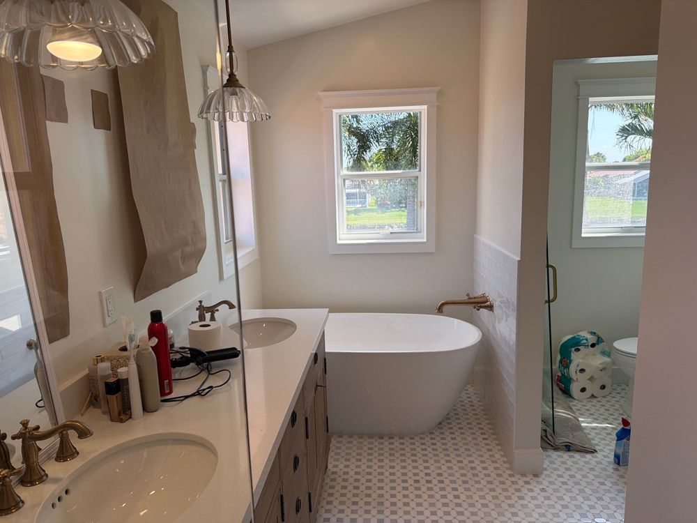 Remodeled bathroom with freestanding tub by H&H Signature Renovations