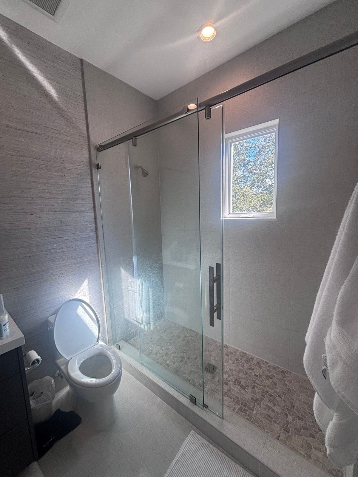 Walk-in shower with glass enclosure in a South Florida bathroom
