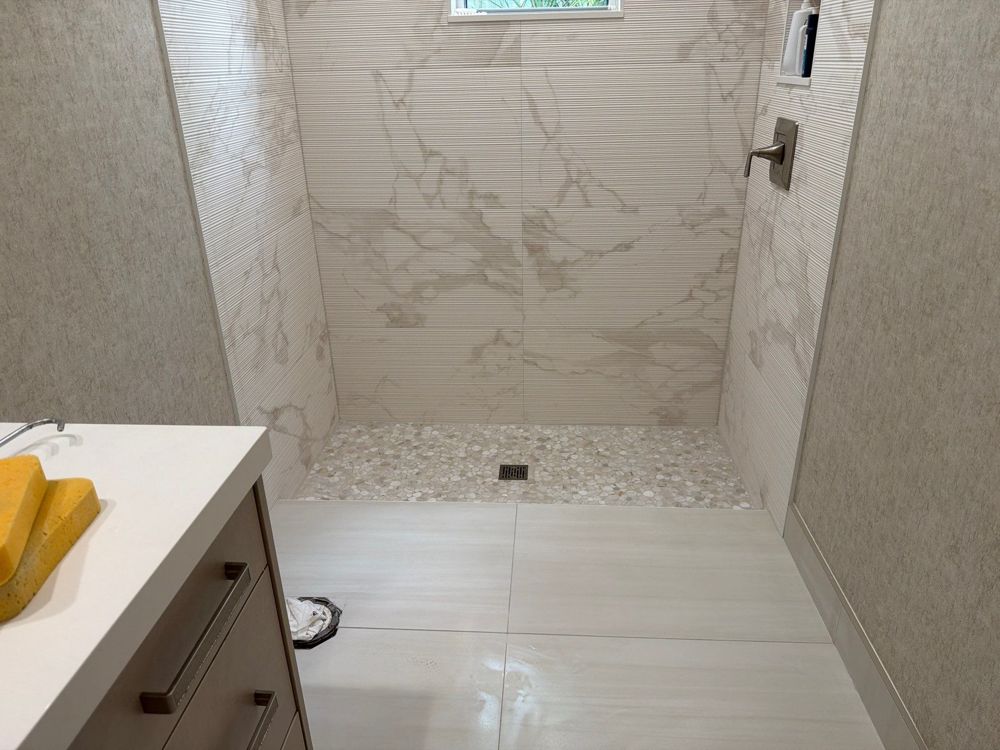 Marble walk-in shower in a Palm Beach County bathroom